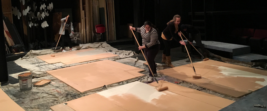 Painters work on a set.