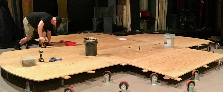 Workers construct a scene.