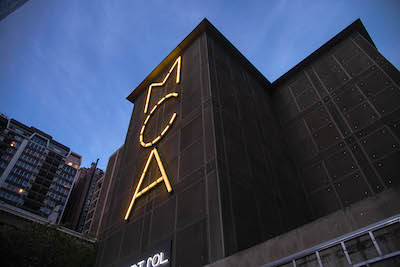 A photo of the exterior of the Museum of Contemporary Art Chicago lit up at night.