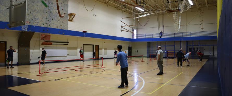 Faculty, Staff, and Students playing pickleball.