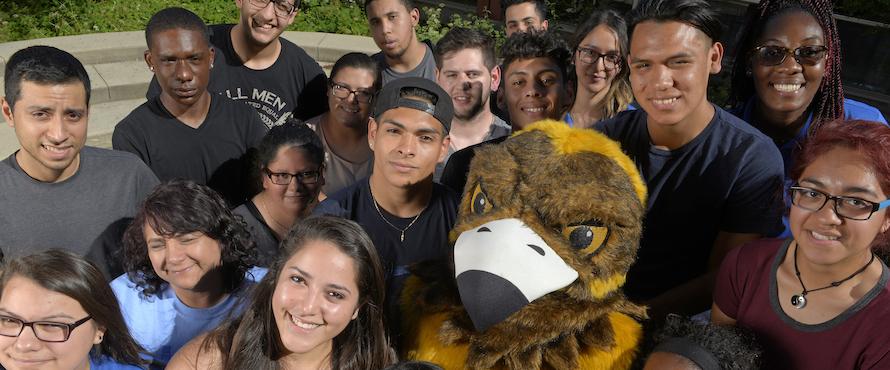 A photo of Goldie surrounded by students