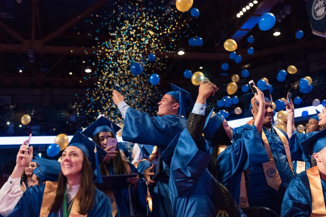 Confetti and balloons rain down on NEIU students during commencement