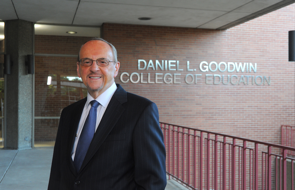 Daniel L. Goodwin poses in front of the Daniel L. Goodwin College of Education building