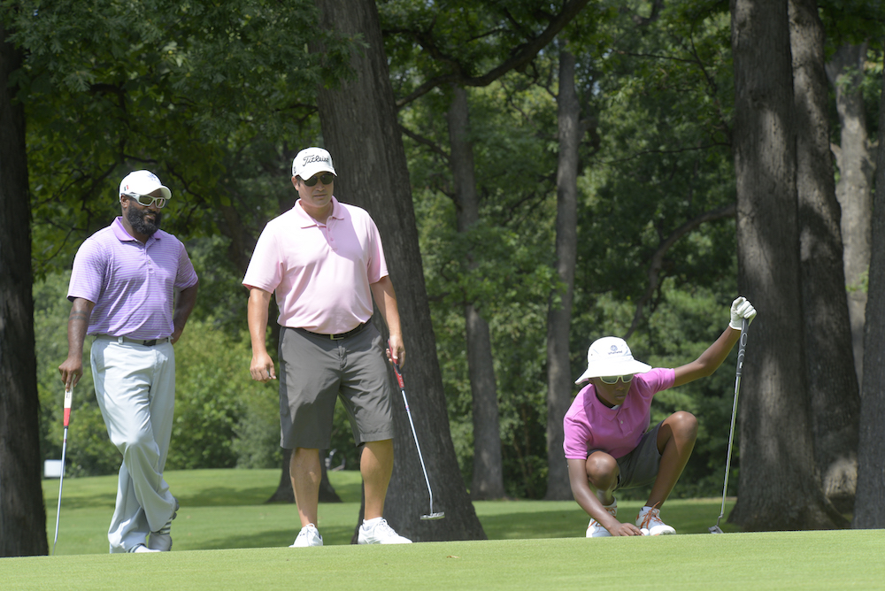 Three golfers stand on the green at Eaglewood Resort and Spa in Itasca, Illinois