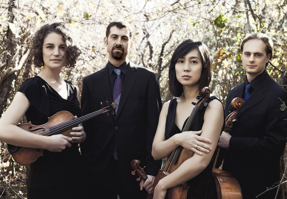 The members of the Chiara String Quartet pose outdoors