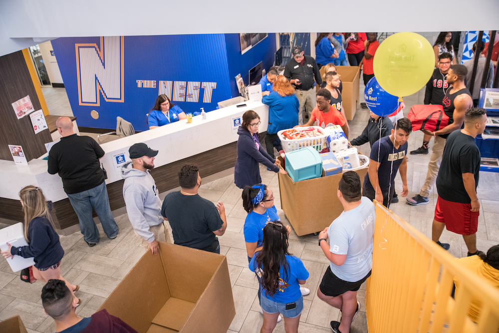 The lobby of The Nest residence hall is packed with students and parents on Move-In Day.