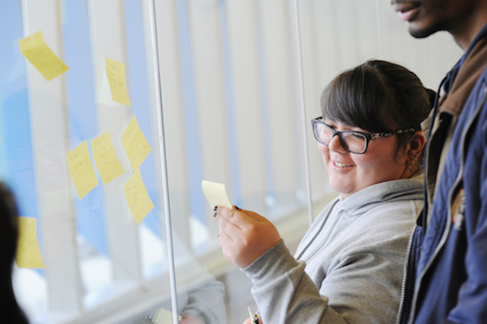 People walk the sunlit hallway of El Centro