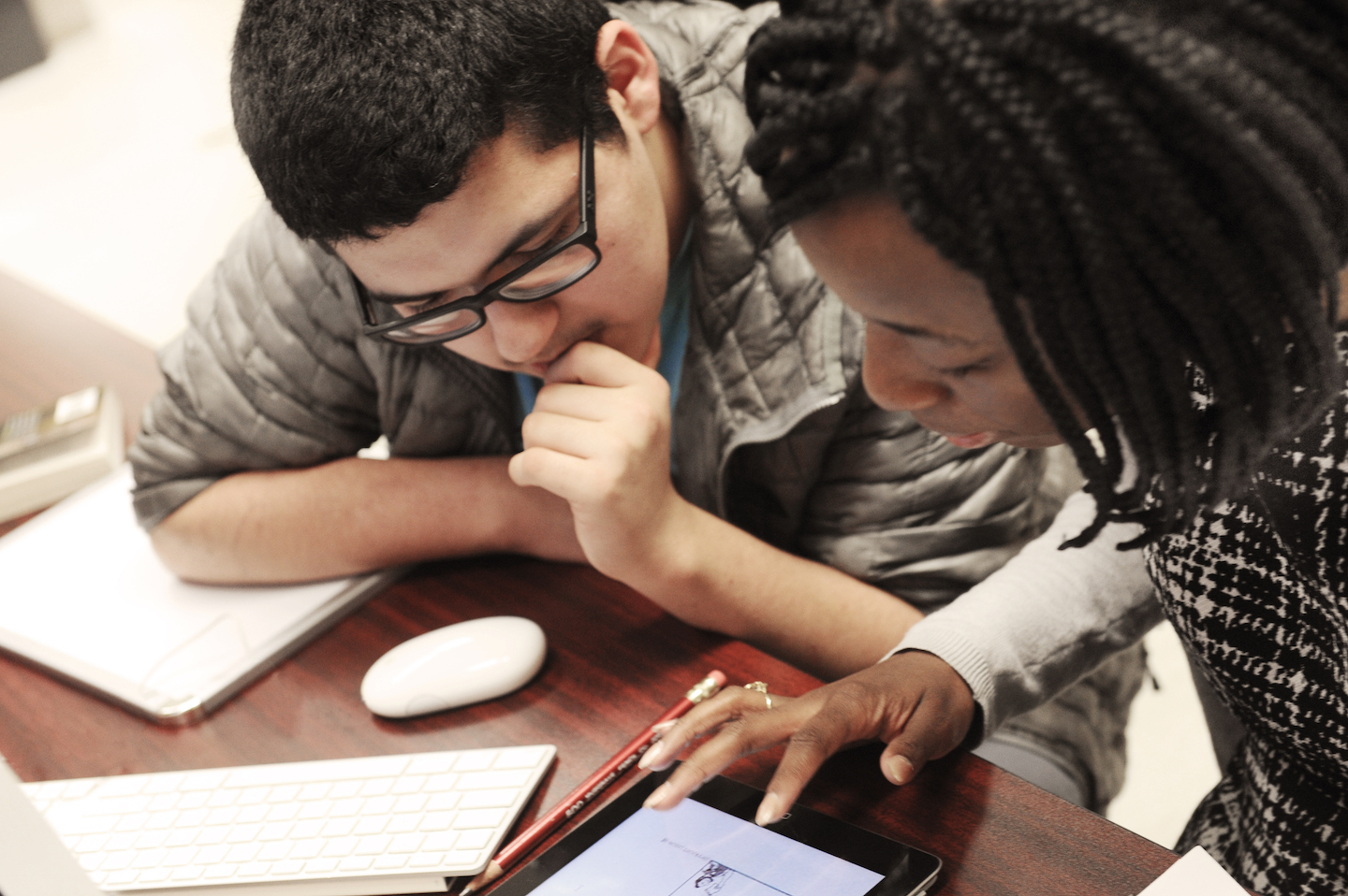 Graduate students sit next to each other