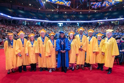 Ana Castillo (far left) and President Bell-Jordan (center) with the Golden Alumni