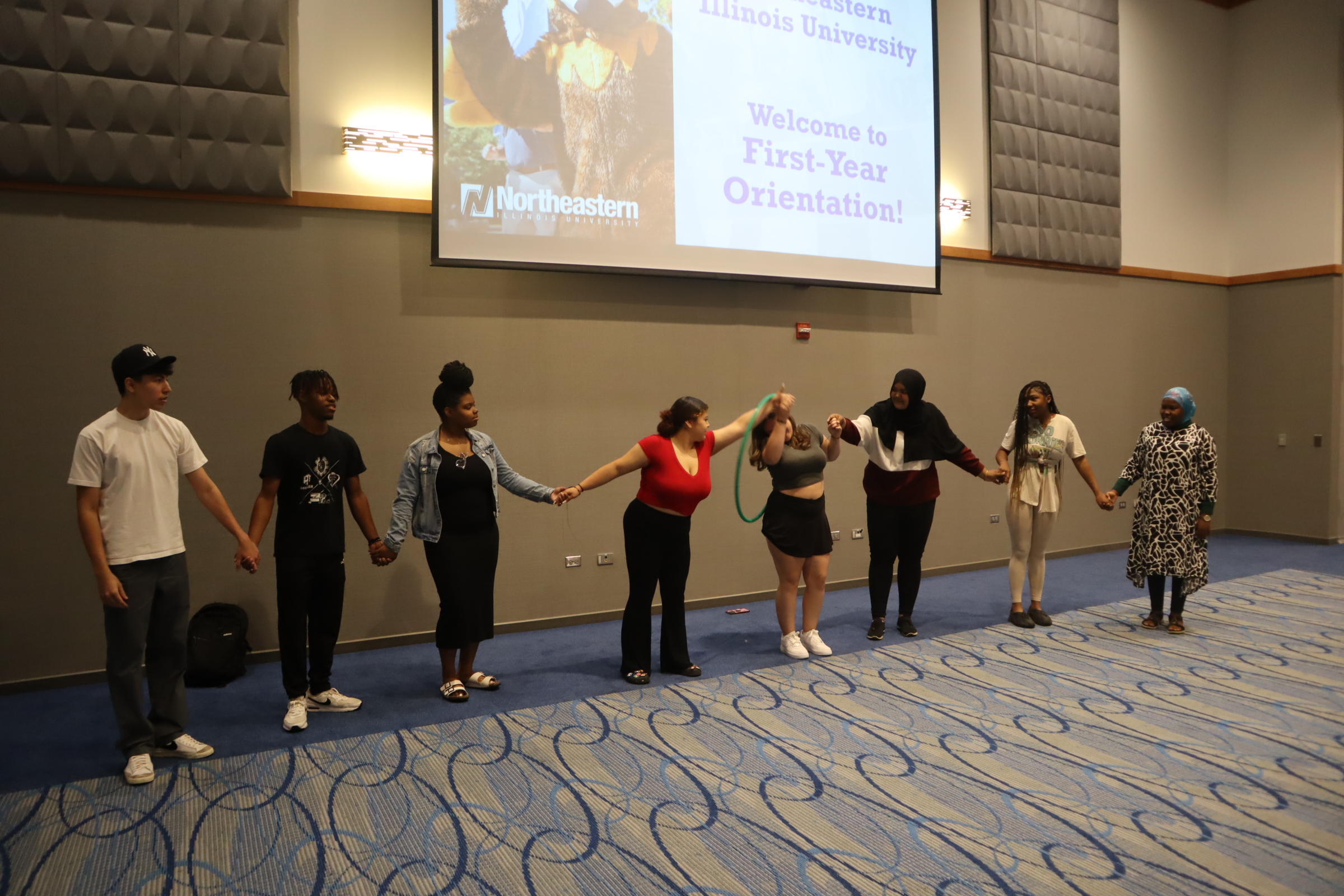 Students performing ice breakers at freshman orientation