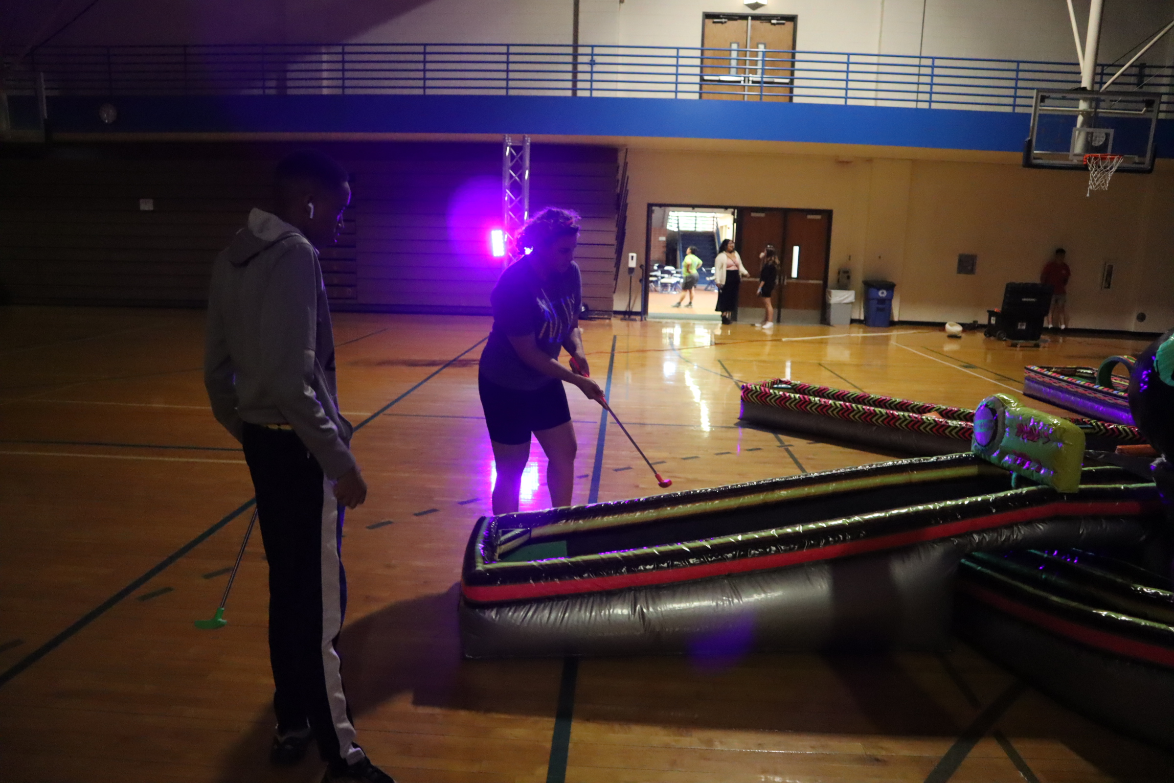 Students playing mini golf at an event