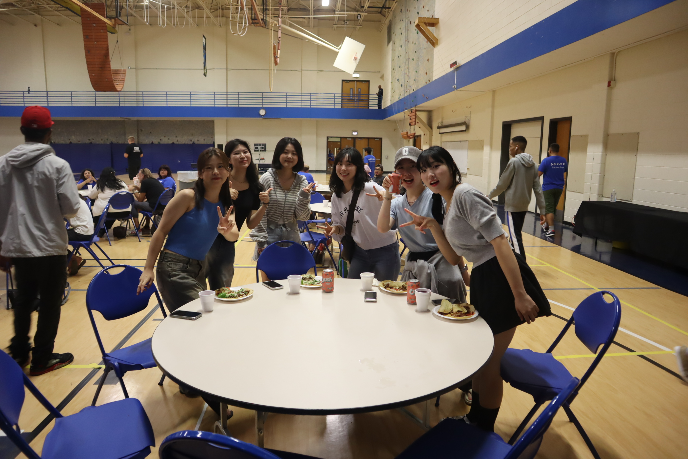Students posing for a picture at a table