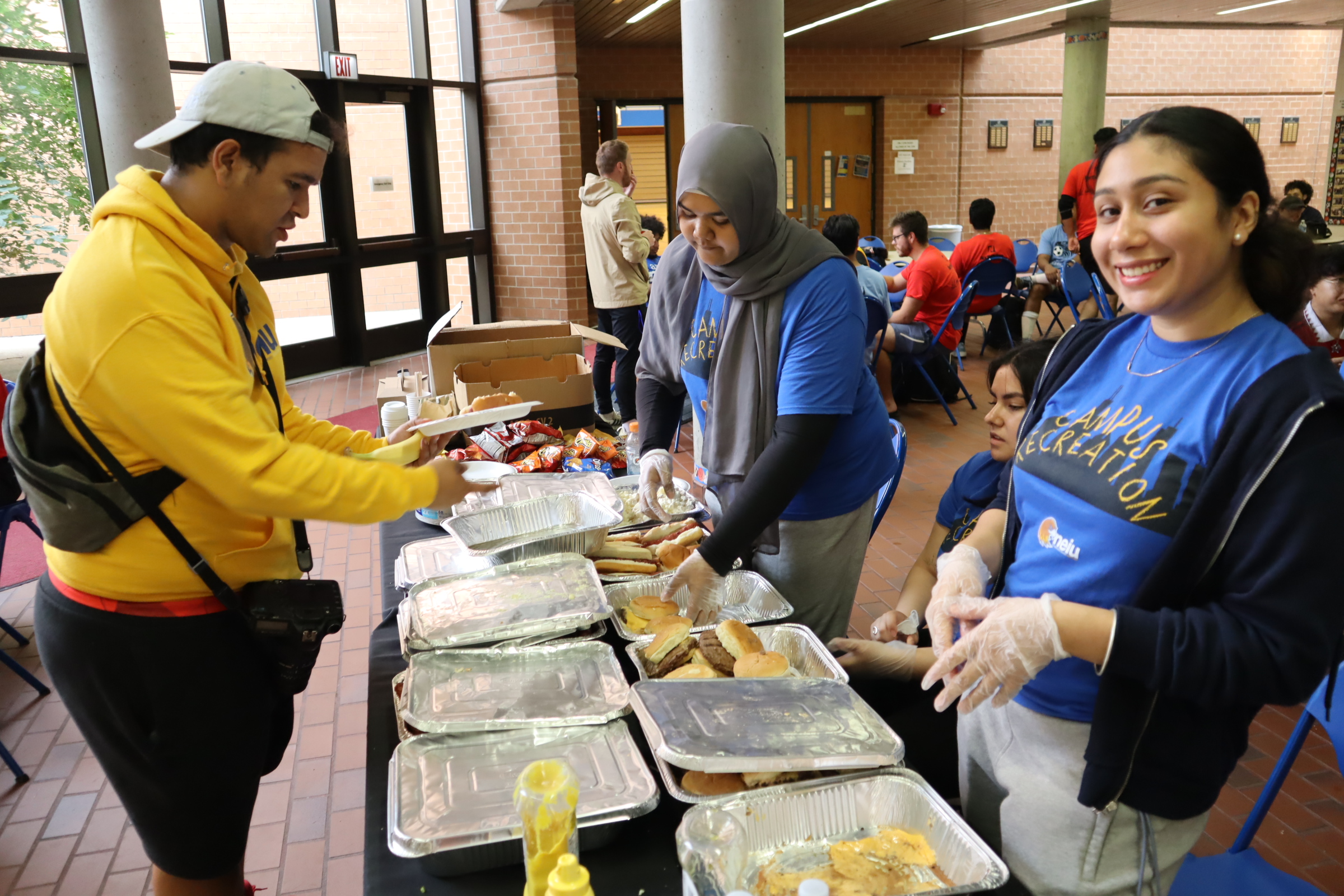 Students serving food at a fundraising event
