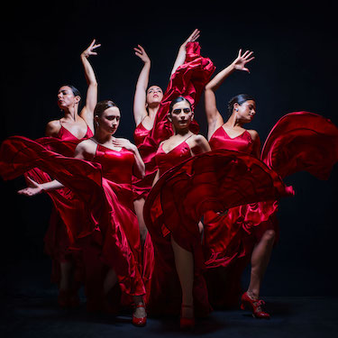 Ensemble Español dancers in red dresses performing in "Viejos Aires." Photo by Joel Maisonet.