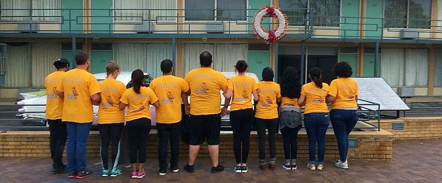 Northeastern students wore yellow NEIU shirts on a 2017 Alternative Spring Break trip while standing outside the National Civil Rights Museum in Memphis, Tenn., looking at the balcony where Dr. Martin Luther King Jr. was shot.