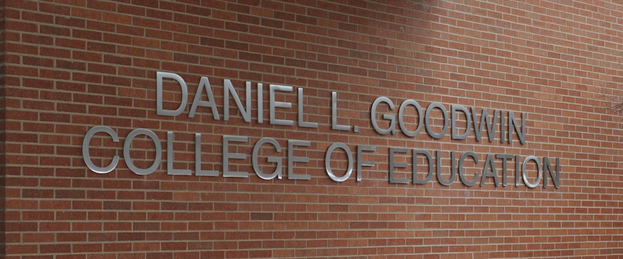 Metal lettering attached to the brick exterior of Lech Walesa Hall that reads Daniel L. Goodwin College of Education