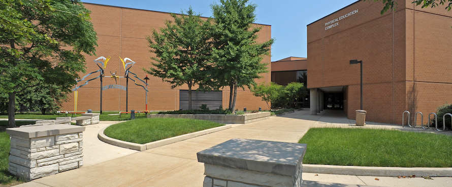 A photo of the exterior of Northeastern's P.E. Complex on a sunny day.