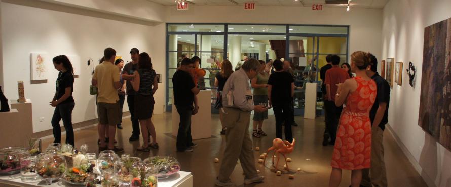 People mingle in the gallery during an opening.