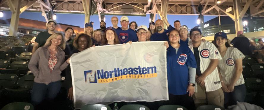 NEIU Alumni pose for group photo at Chicago Cubs game.