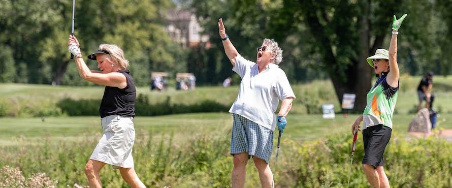 A photo of Chuck Kane's daughters, Mary and Liz Kane, and their cousin, Eleanor Halt, playing a round of golf during the Chuck Kane Golf Outing. 