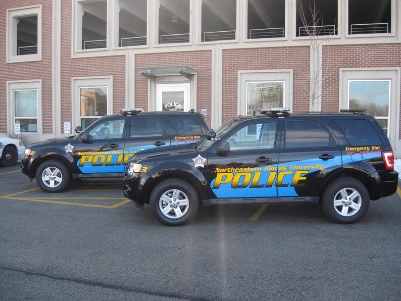 Police cars are shown parked at Northeastern.